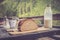 Rustic breakfast on an alpine hut: fresh crisp bread and milk in glass bottle, outdoors