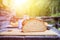 Rustic breakfast on an alpine hut: fresh crisp bread and milk in glass bottle, outdoors. Sunshine