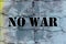 Rustic brick wall with no war sign. Pacifism concept