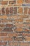 Rustic brick wall with ornamental arch in various sized cutouts as background