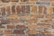 Rustic brick wall with ornamental arch in various sized cutouts as background