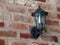 Rustic brick wall in Yorkshire village with decorative cast iron wall light