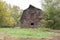 Rustic brown barn surrounded by green trees