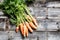 Rustic bunch of organic carrots with tops for healthy diet