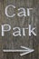 Rustic car park directional sign with arrow