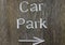 Rustic car park directional sign with arrow