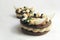 Rustic chocolate Paris Brest choux pastry rings with hazelnut ganache, nuts, apple slices, black currants and hazelnut