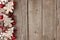 Rustic Christmas side border with wood ornaments and berries on aged wood