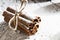 RUSTIC CINNAMON STILL LIFE ON SNOW COVERED BACKGROUND