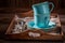 Rustic coffee cup and a plate on old wooden tray