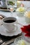 Rustic coffee cup on the table with fresh flowers