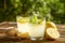 Rustic composition with freshly squeezed homemade cold lemonade in bottle and glasses with condensation droplets.