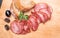 Rustic composition with a smoked, dry Krakowska sausage. Traditional Polish meat cold cuts.