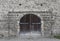 Rustic cracked wall with old wooden door. Stone texture