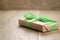 Rustic craft paper gift box with green ribbon bow on wood table