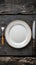 Rustic dining style Empty plate, fork, knife on gray wood