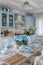 Rustic dining table set with blue glassware and floral centerpiece