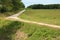 Rustic dirt path between the green fields of Tuscany