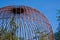 Rustic domed cage protecting gardening supplies in a beautiful Thai garden park.