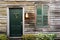 Rustic door and window with closed shutters