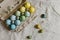 Rustic easter flat lay. Stylish easter eggs and blooming cherry branch on rustic table. Happy Easter! Natural painted eggs in