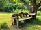 Rustic Elegance: A Cozy Tree Bench in a Quaint Countryside Garden