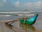 Rustic fishing boat with one outrigger in the afternoon light at Talala Beach in Sri Lanka