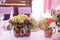 Rustic flower arrangement in a golden vase at a wedding banquet.