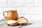 Rustic food. A cup with a drink, bread with poppy seeds on the kitchen table