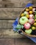 Rustic garden apples, plums, black chokeberry on a rough Board table, top view