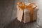 Rustic gift box with orange ribbon bow and empty tag