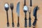 Rustic handmade cutlery set on wooden board