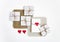 Rustic handmade gift boxes on white background decorated with hearts. Top view, flat lay