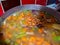 Rustic, healthy and nutritious red lentil broth cooking on the hob