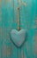 Rustic heart on turquoise wooden surface for valentine, birthday