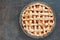 Rustic homemade peach pie, above view on stone background