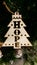 Rustic HOPE wooden Christmas ornament on rope string against a dark blurred Christmas tree