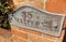 Rustic House name plate on brick