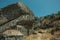 Rustic houses with stone wall inside big rock at Monsanto