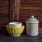 Rustic kitchen still life. vintage ceramic bowl and enameled jar