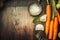 Rustic kitchen table with carrots , cooking spoon and flavor , top view