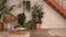 Rustic lounge with rattan armchair and coffee table, parquet floor, iron metal staircase. Brick walls, white and orange industrial