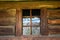 Rustic mood. Title: Wooden wall with window. Rustic style. Ecological housing.