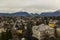 Rustic moody town urban view from above depressive gray colors cloudy weather time living buildings foreground and Alps mountains