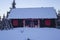 Rustic mountain cabin covered in snow