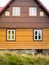 Rustic mountain cottage front in brown and yellow