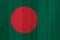 A rustic old Bangladesh flag on weathered wood