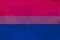 A rustic old bisexual flag on weathered wood