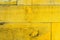 Rustic old grungy and weathered yellow wall wooden planks as wood texture