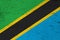 A rustic old Tanzania flag on weathered wood